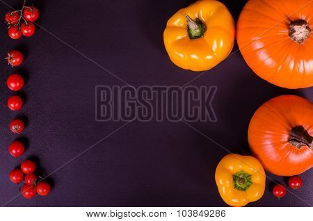 Fresh vegetables on a black table. Autumn background.