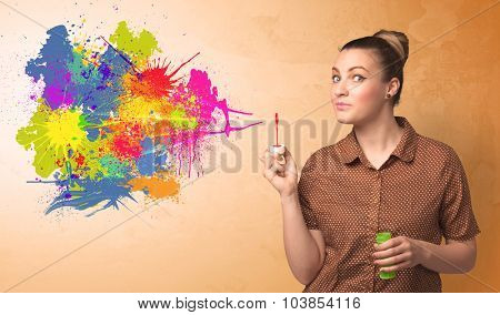 Cute girl blowing bubble spalsh graffiti into wall
