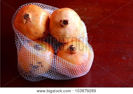 Pomegranate in a white net