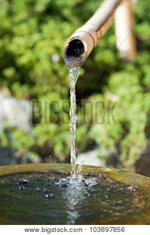 Bamboo Tube And Flowing Water