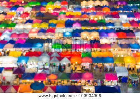 Abstract blurred lights of multiple colour aerial view city flea market