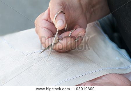 Senior Woman Holding Scisor And Knitting