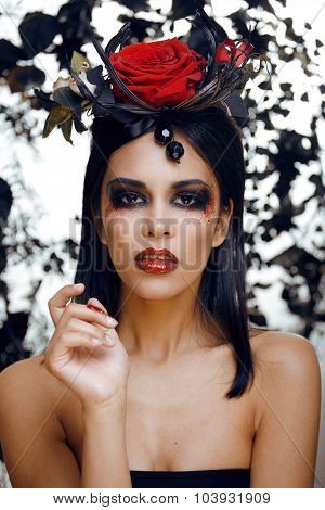 pretty brunette woman with rose jewelry, black and red, bright make up kike a vampire closeup red li