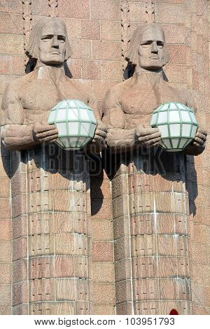 Statues holding the spherical lamps