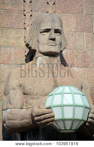 Statues holding the spherical lamps