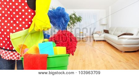 Maid hands with cleaning tools. House cleaning service concept.
