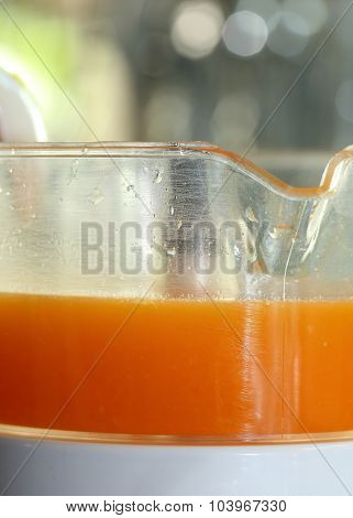 Fresh Orange Juice In Juicer Machine With Hand