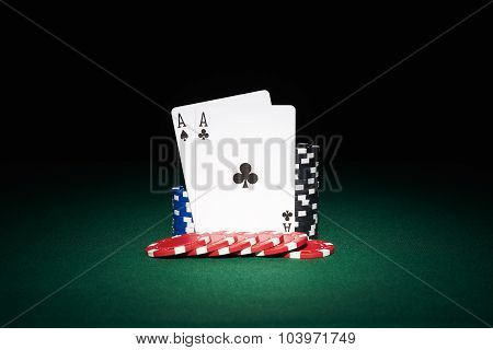 Poker Chips On Table With Aces Cards