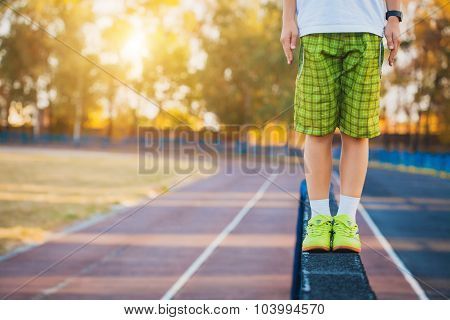 Legs of a gymnast on the balance beam apparatus