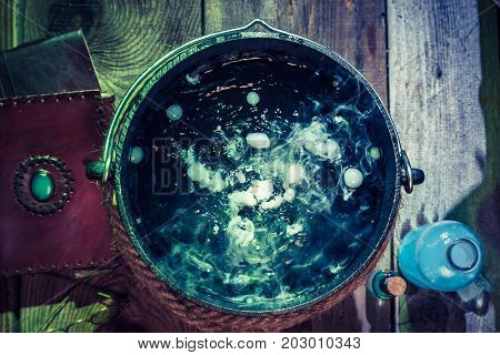 Closeup Of Witcher Cauldron With Books For Halloween