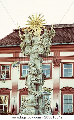 Holy trinity column and Goose on a string theatre building Brno Moravia Czech republic. Baroque architecture. Symbolic object. Old photo filter.