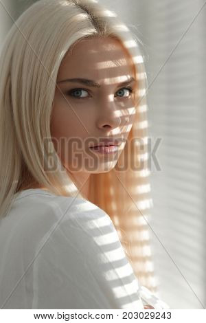 Close-up of a pensive young business woman looking out the windo