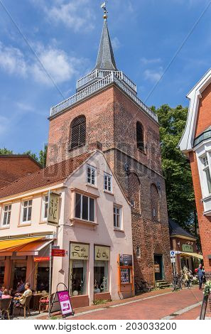 AURICH, GERMANY - JULY 18, 2017: Lamberti church and shop in the historical center of Aurich, Germany