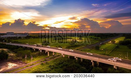 Aerial Photo Countryside Car Running on Road Bridge Over Railway and Golden Hour Sky Beautiful Landscape Drone View