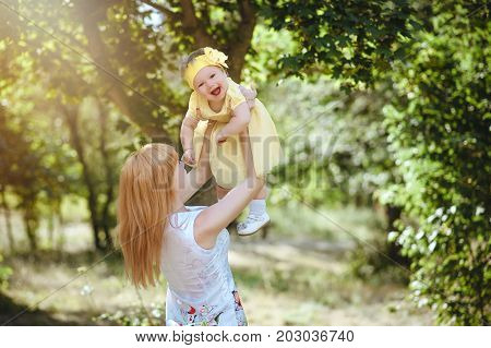 Mom throws her daughter in the sun.