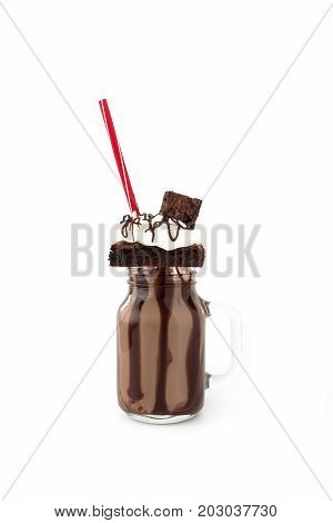 Homemade Chocolate Freakshake Milkshake with brownies chocolate sauce and whipping cream on white background with copy space.