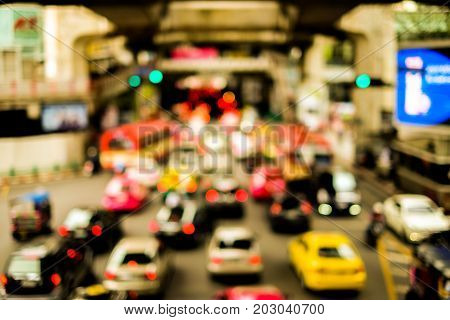 Blurred lines traffic road with bokeh street of town and cars at Bangkok Thailand for travel background or texture - slow life and vintage color style.