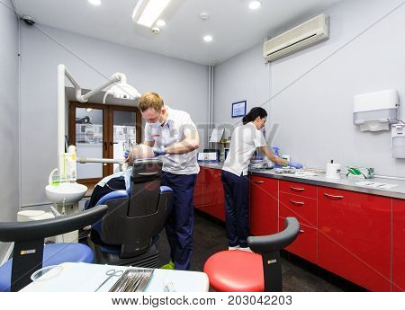 Moscow, Russia. June 2017 The dentist and the assistant work on the patient in the clinic