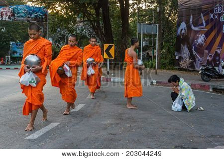 CHIANG MAI THAILAND - 1/8/2016: Monks collect donations in Chiang Mai Thailand.