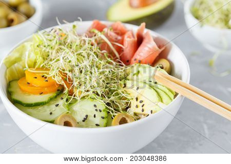 Hawaiian fish poke with rice avocado and sprouts.