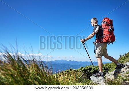 Hiking in the mountains with a backpack in the summer.