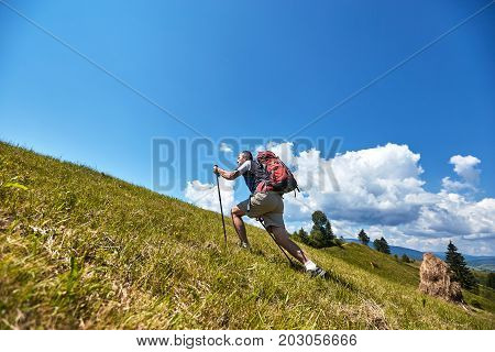 Hiking in the mountains with a backpack in the summer.