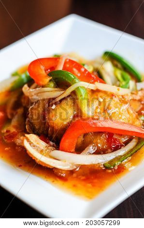 Red Hot Snapper, Fried red snapper fillet topped with hot peppers, onions, fresh garlic & bell peppers mixed in sweet & sour sauce.