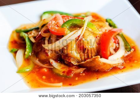Red Hot Snapper, Fried red snapper fillet topped with hot peppers, onions, fresh garlic & bell peppers mixed in sweet & sour sauce.