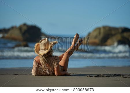 young woman relaxing on the beach in summer day