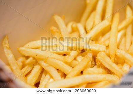 French fries serve in paper box for fast food background or texture.