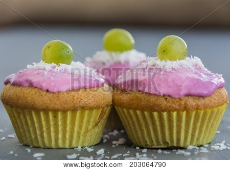 Tasty cupcakes with grape and coconut chips