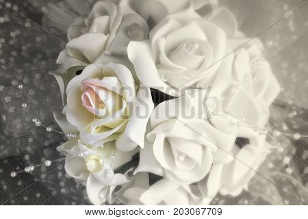 Old photo of a wedding bridal bouquet. Vintage.Blur?bokeh. Indoors. Texture and toning of paper. The decoloured photo. Locally - color. Photo.