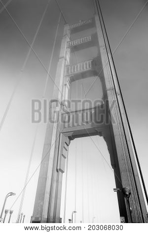 Part of the famous Golden Gate Bridge. The ocean coast near San Francisco California. Black and white.