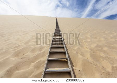 Ladder to the Dune of Pilat - the tallest sand dune in Europe. The dune is located in La Teste-de-Buch in the Arcachon Bay area France