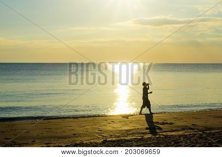 The man drinking water at Chaolao Tosang Beach Thailand.