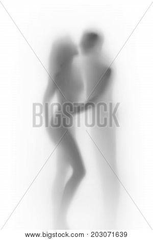Body silhouette of sexy lover couple, behind a diffuse surface