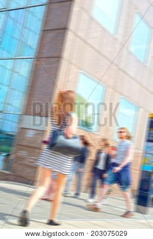 blurred summer commuters walking to work in london city