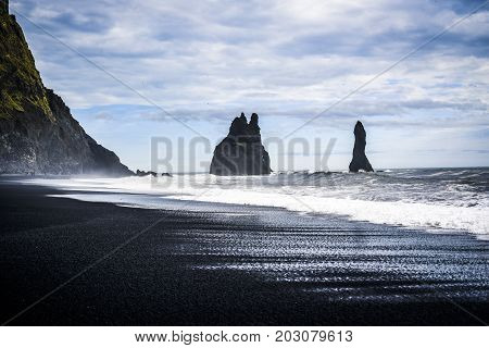 Reynisfjara beach with a view of the protruding rocks of the large waves