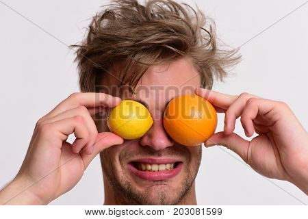 Man With Orange And Lemon Instead Of Eyes In Hands