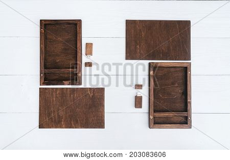 Empty blank wooden boxes for gift or photos with usb stick free space. Packaging for photo and USB drives on white wooden background. Information and mail concept