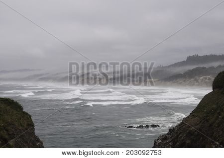 Oregon coast waves with clouds and fog rolling in