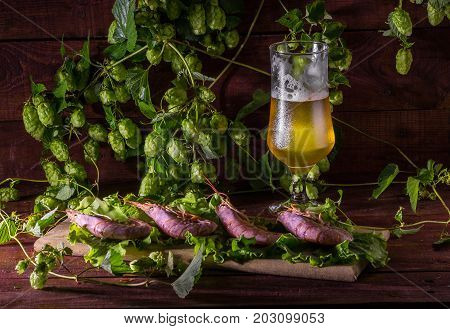 still life with Beer, shrimps and salad on a wooden table