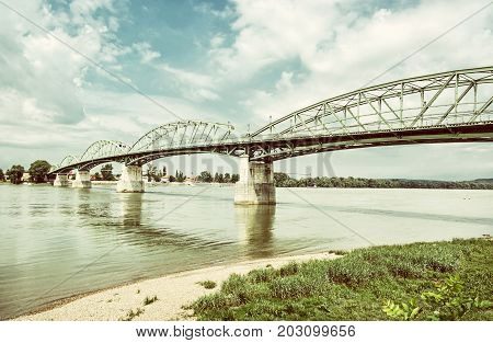 Maria Valeria bridge joins Esztergom in Hungary and Sturovo in Slovak republic across the Danube river. Transportation theme. Architectural scene. Old photo filter.