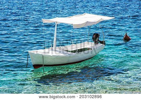 Anchored little boat in Maslinica Solta island Croatia. Summer vacation destination.