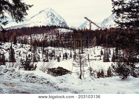 Solisko peak with springboard for ski jumping Strbske pleso Slovak republic. Winter mountains. Retro photo filter.