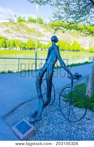 Salzburg, Austria - May 01, 2017: Nude bronze statue of Radfahrer Cyclist by Lotte Ranft next to Makartsteg bridge in Salzburg, Austria on May 01, 2017