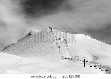 Black and white view on ski and chair-lift at sun winter morning. Caucasus Mountains. Georgia region Gudauri Mt. Kudebi.