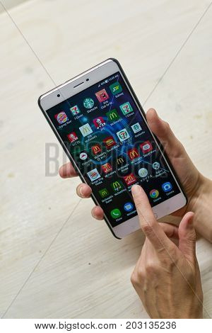 KALININGRAD, RUSSIA - CIRCA SEPTEMBER, 2017: a set of apps on Asus Zenfone 3 Ultra smartphone in woman hands