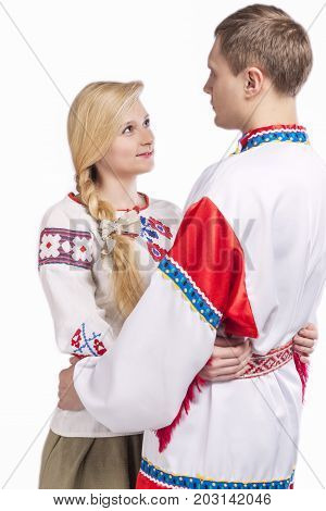 Portrait of Loving Embraced Caucasian Couple in National Belarussian and Russian Decorated Costumes. Against White Background. 