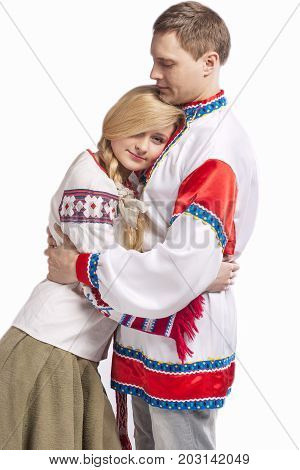 Portrait of Embraced Caucasian Couple Posing in National Belarussian and Russian Decorated Costumes. Isolated Against White Background. 